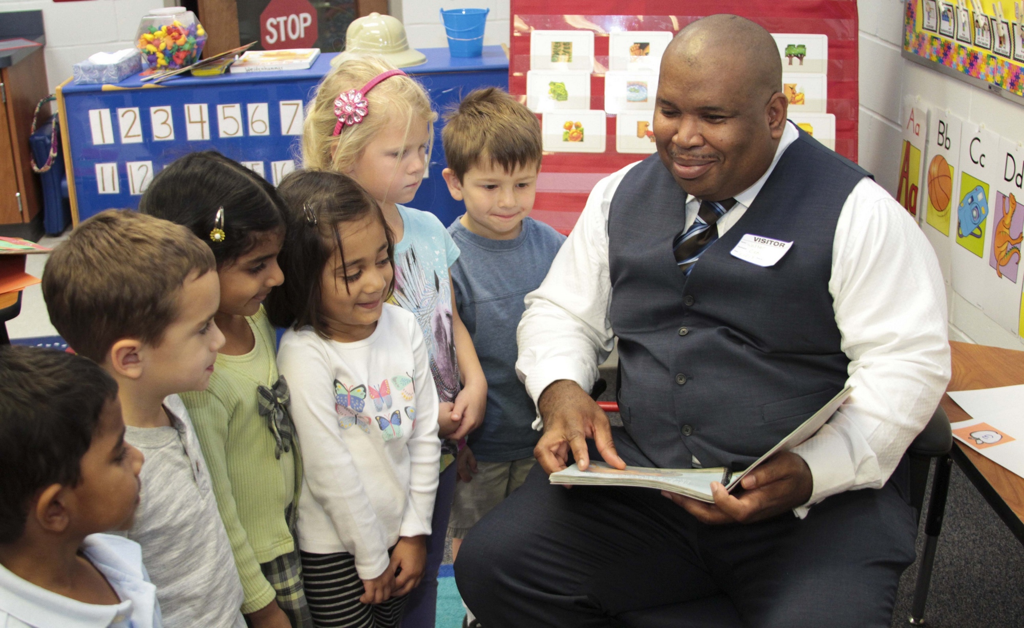 Walter Blackmon showing kids a Braille book